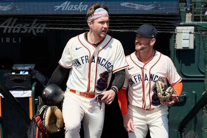 Aug 26, 2023; San Francisco, California, USA; San Francisco Giants catcher Patrick Bailey (14) and bullpen/catching coach Craig Albernaz (0) walk onto the field wearing San Francisco Sea Lions jerseys in honor of the Negro League team that played in San Francisco for one season in 1946 as part of the club's celebration of African American Heritage before the game against the Atlanta Braves at Oracle Park.